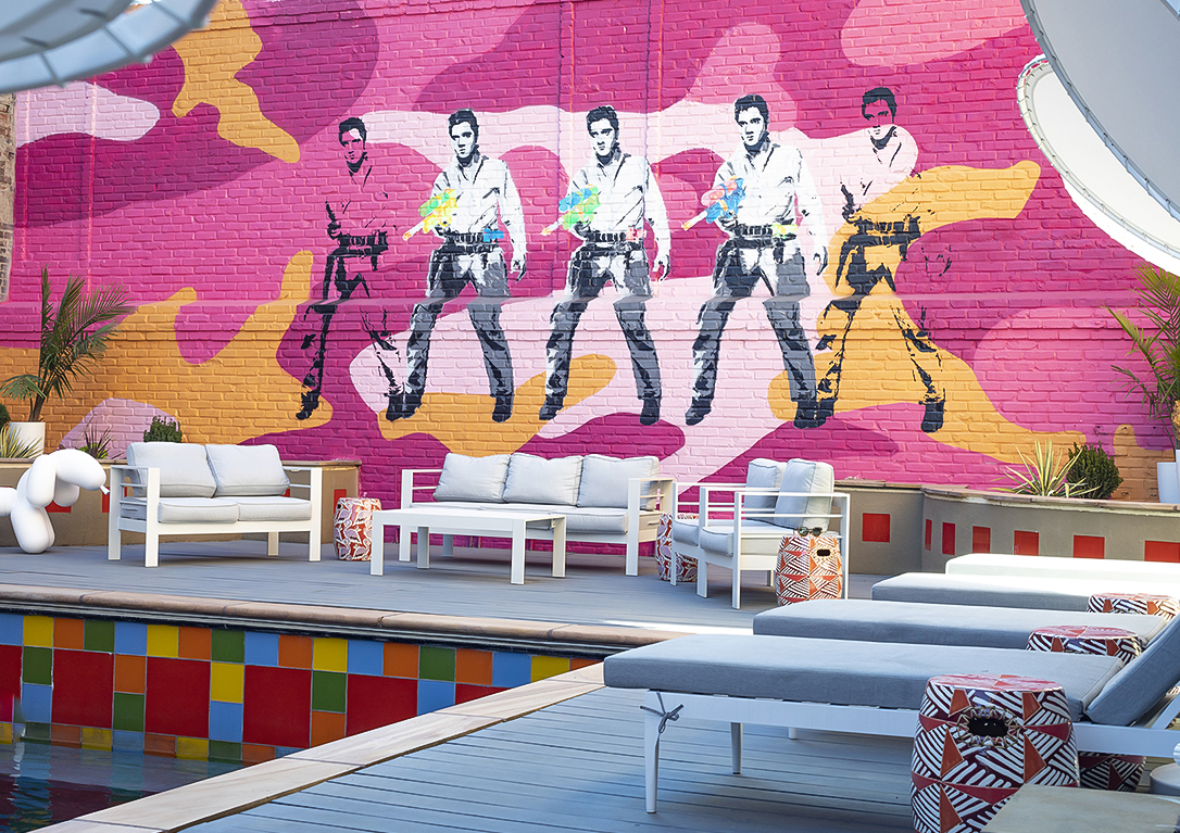 a wall with a painting of a man on it