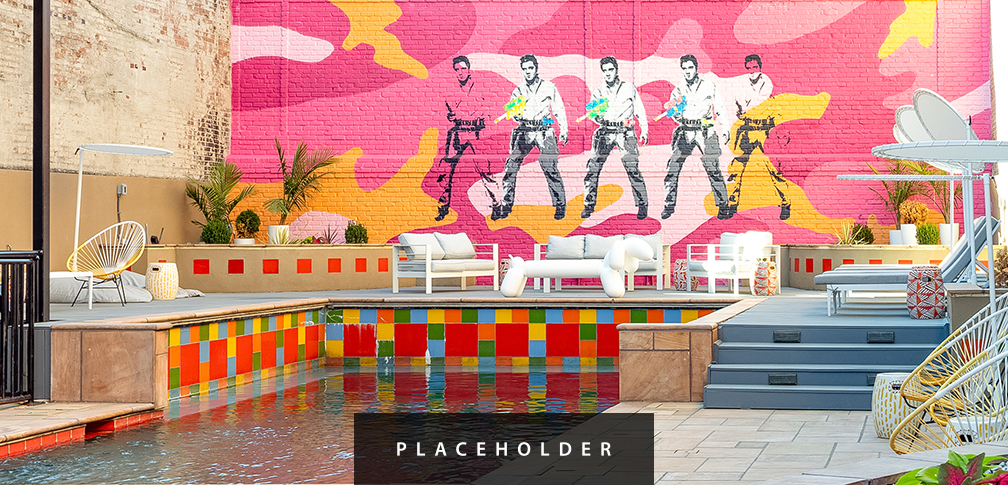 a pool with a painting on the wall