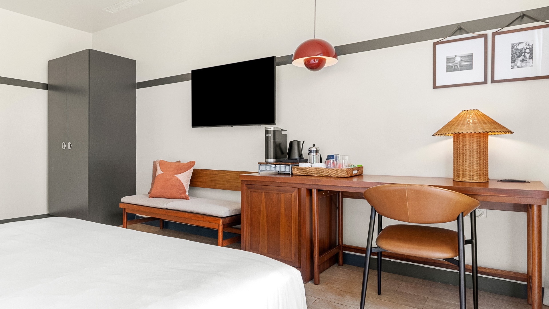 a room with a bed and a table and a tv