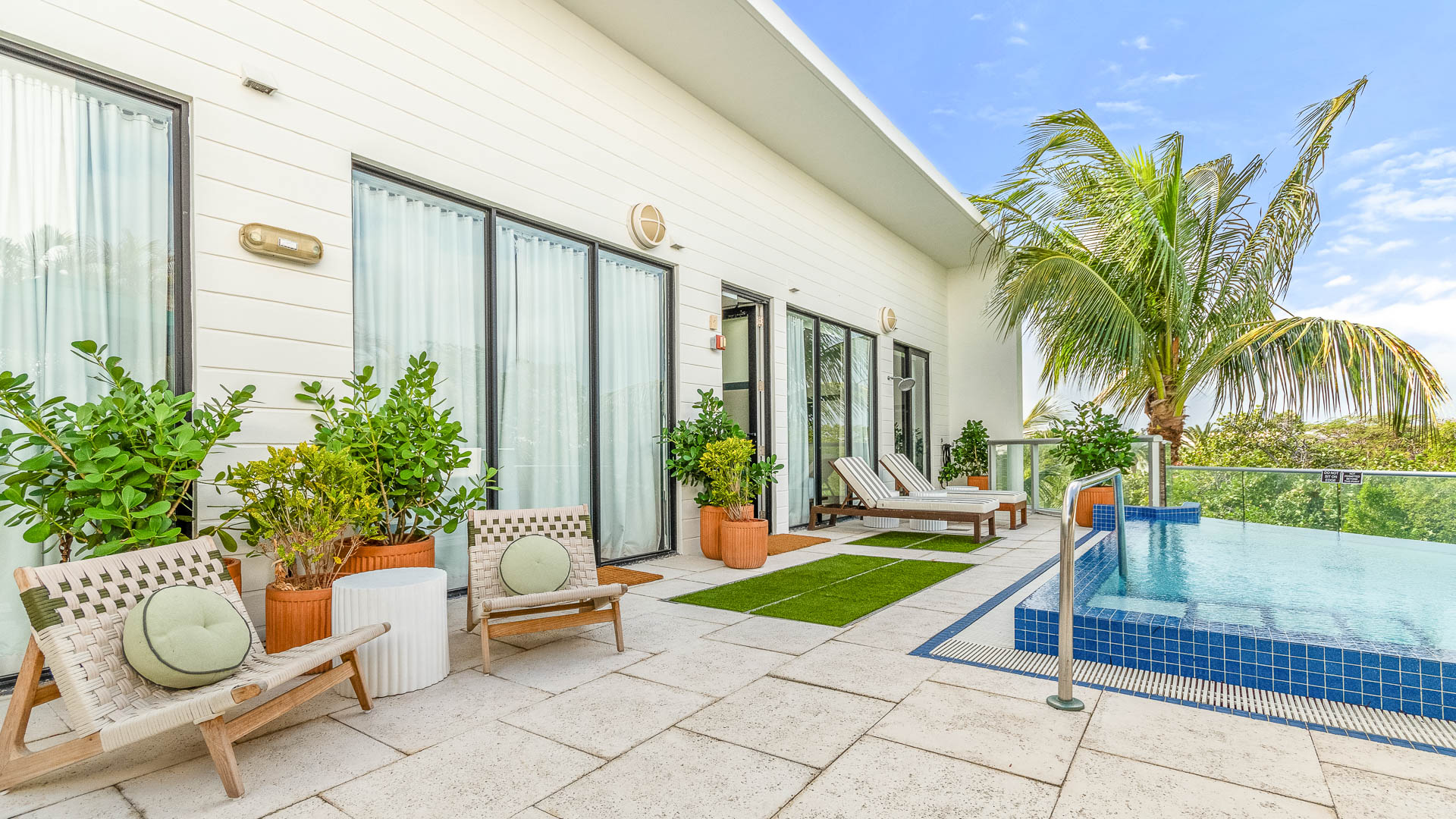 a pool and chairs outside of a building