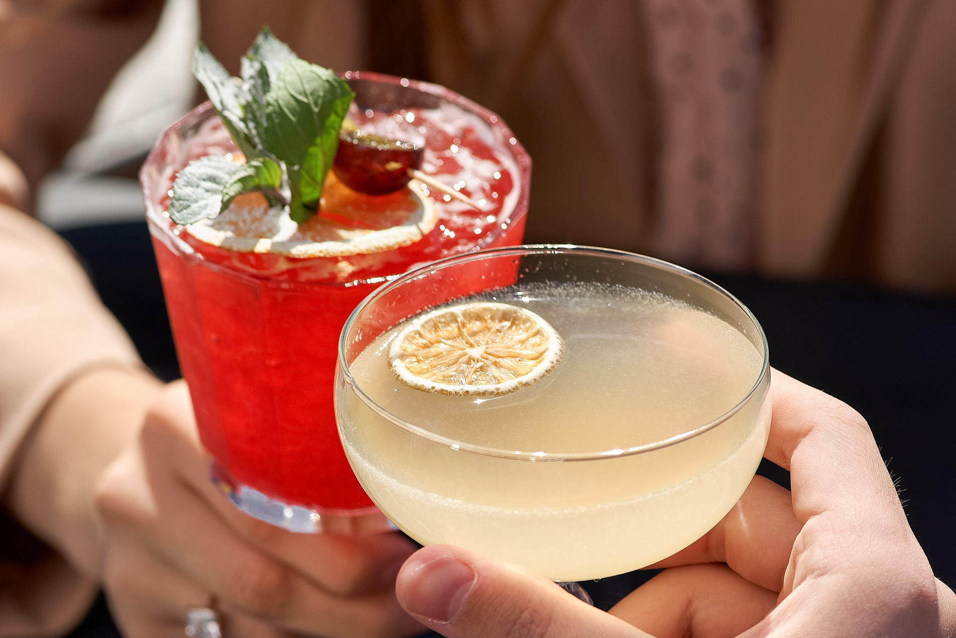 a pair of hands holding drinks