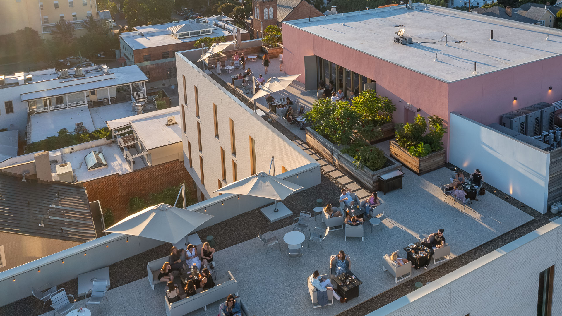 a group of people sitting at tables outside a building