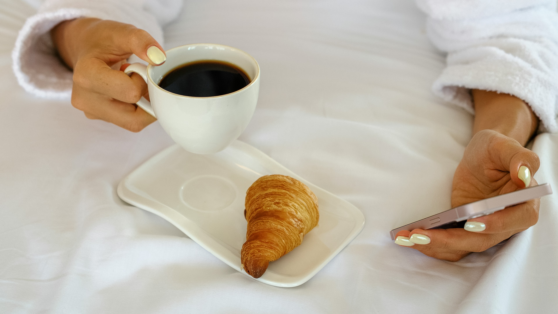 a croissant and a cup of coffee