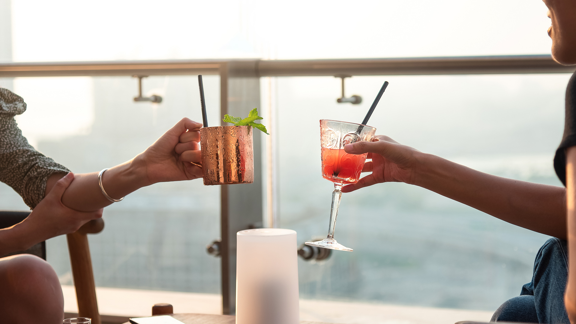 a pair of hands holding drinks