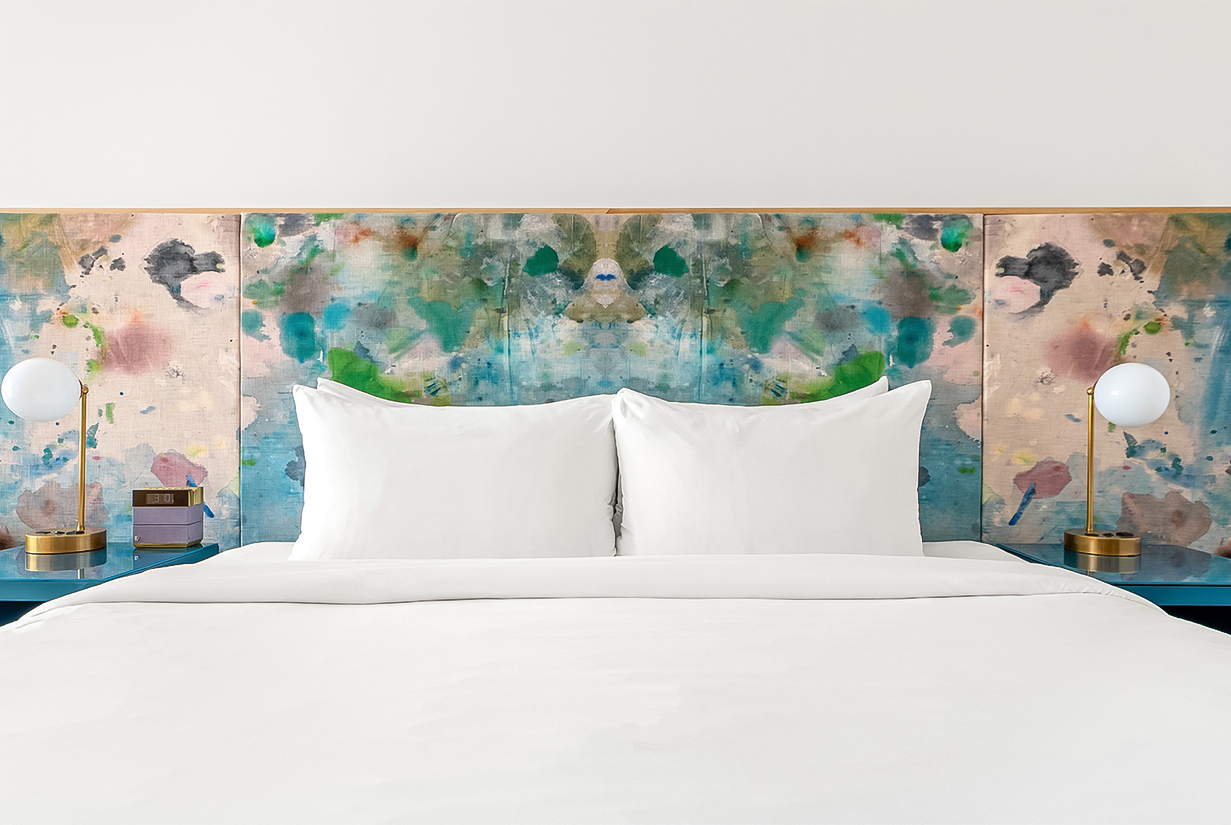 a bed with white sheets and white pillows