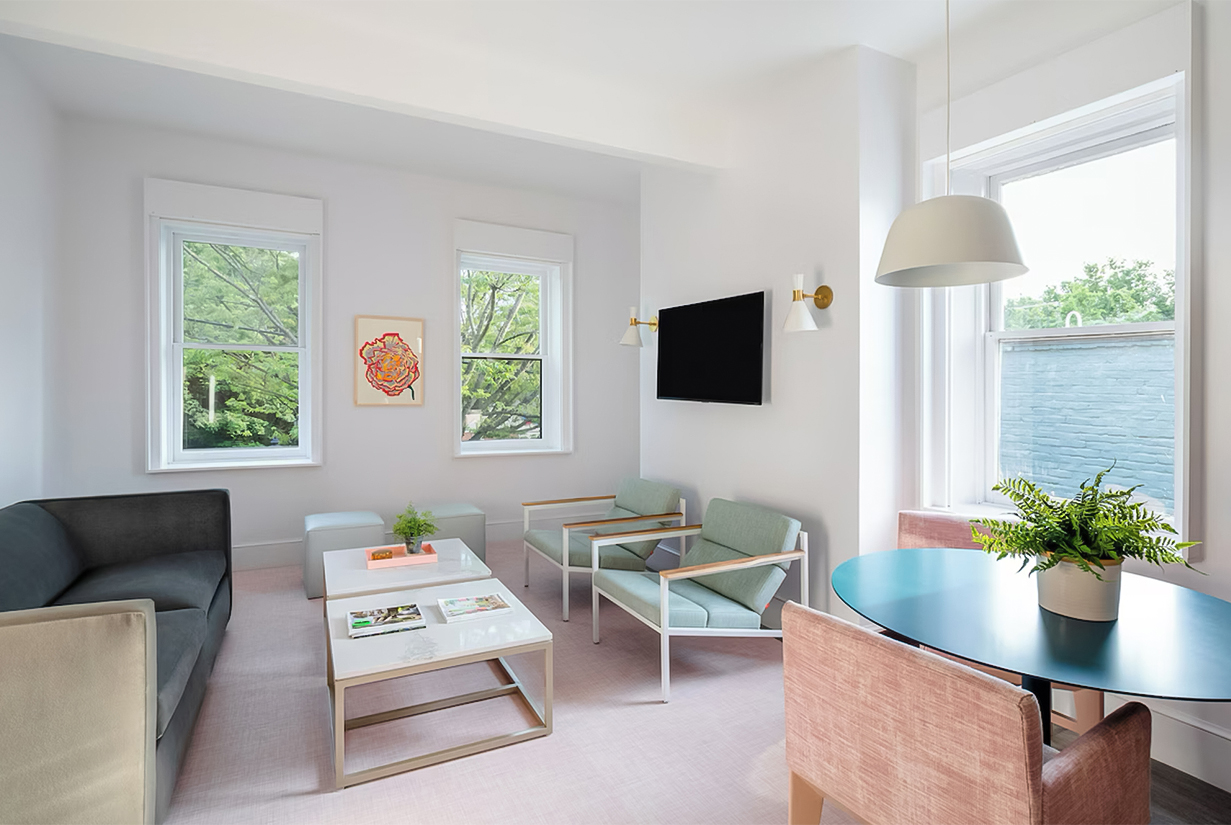 a living room with a couch and chairs