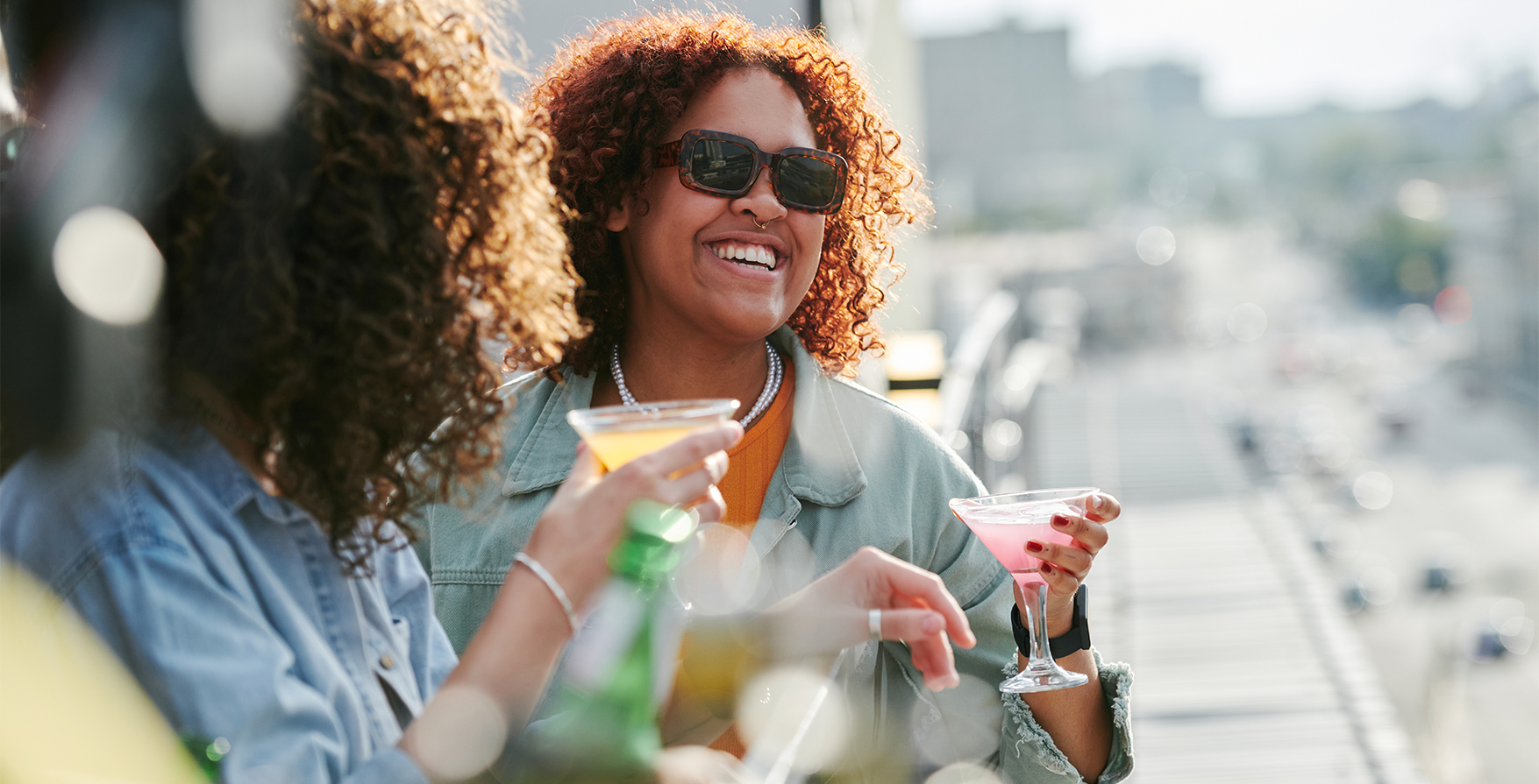 a group of women holding drinks