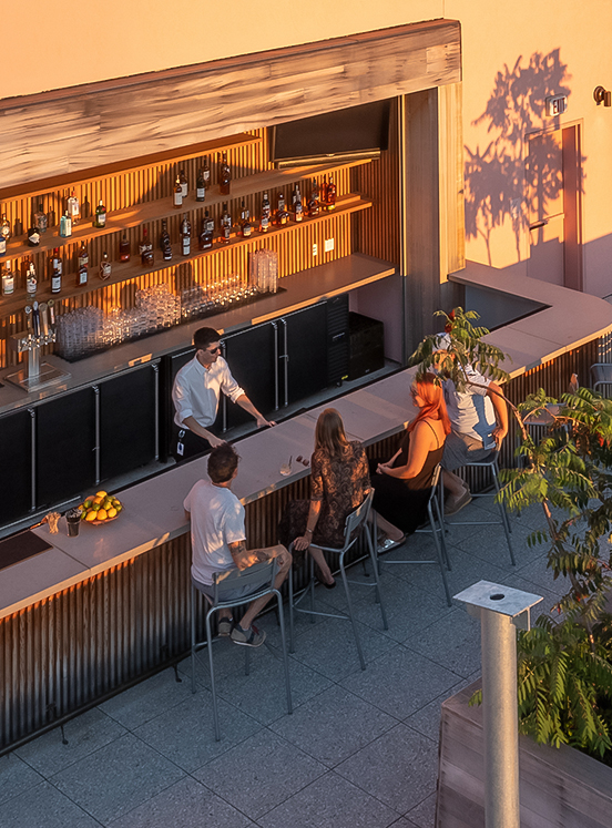 a group of people sitting at a bar