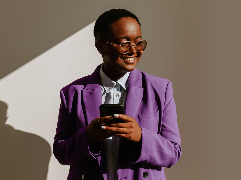 a woman in purple suit holding a phone
