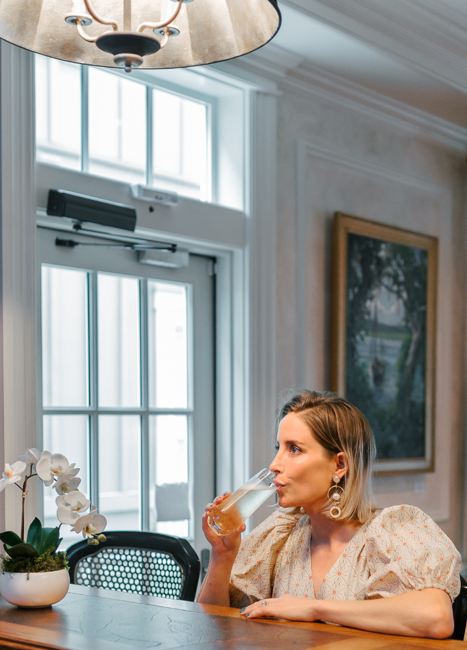 a woman drinking from a glass