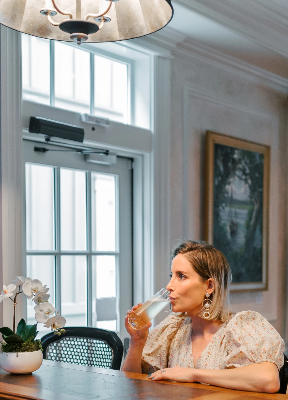 a woman drinking from a glass