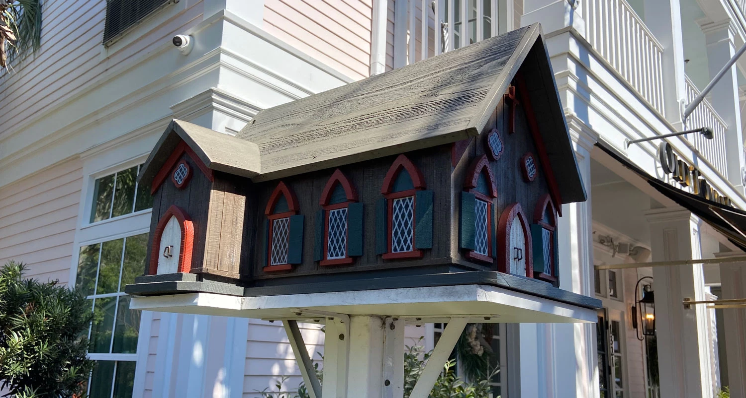 a wooden mailbox with a house on the side