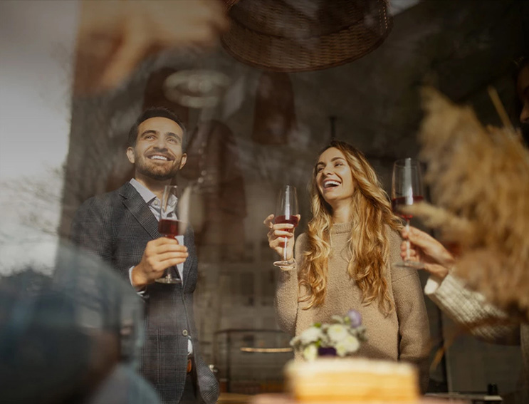 a group of people holding wine glasses