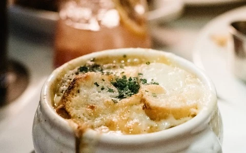 a bowl of soup with croutons on top