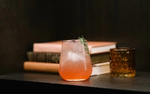 a glass of liquid next to a glass of ice and a glass of liquid