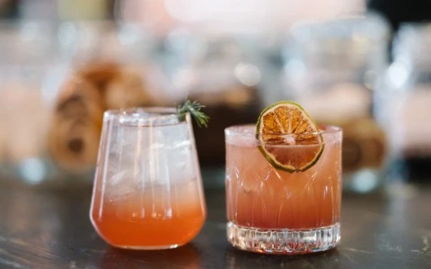 two glasses with drinks on a table