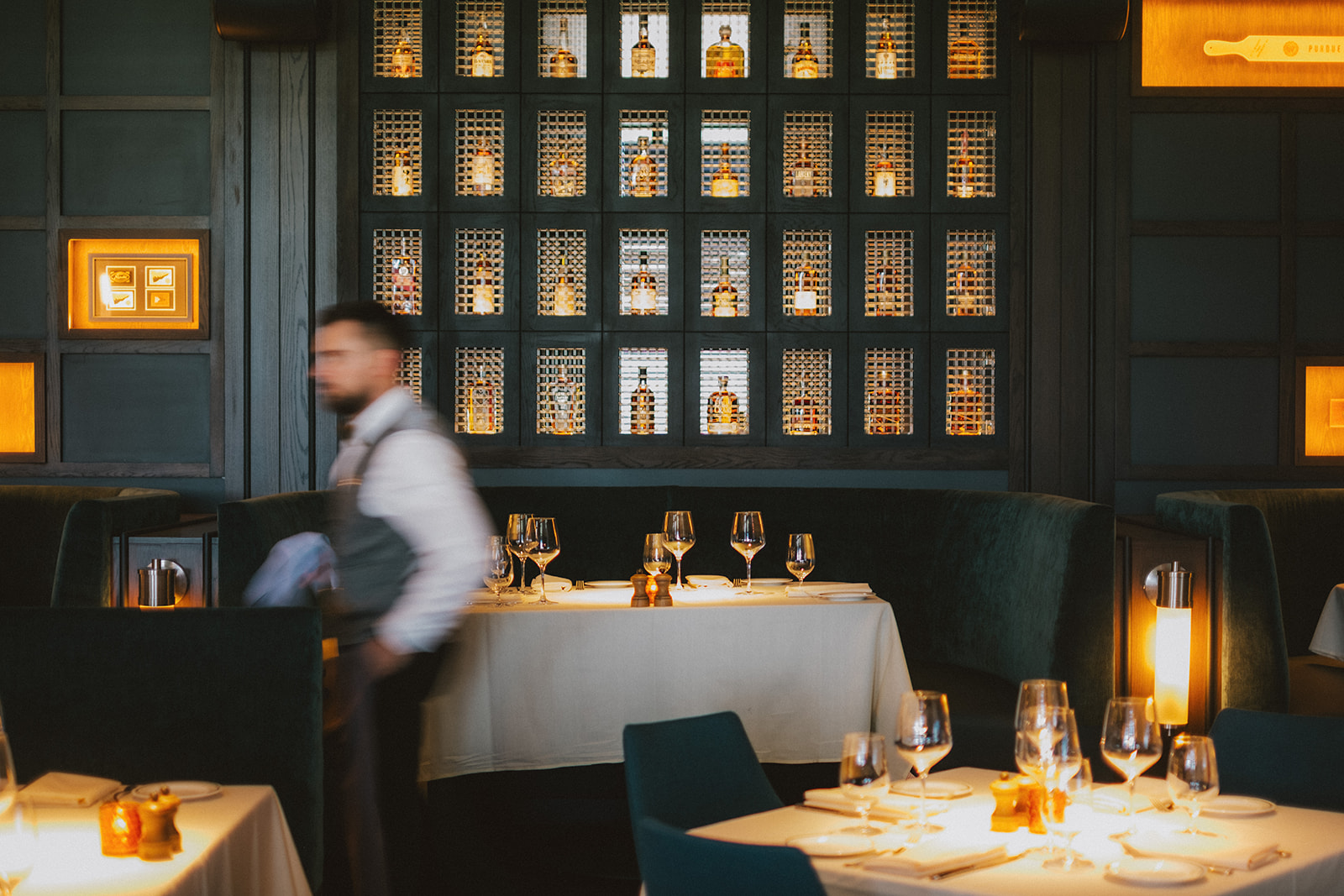 a man standing behind a table with glasses