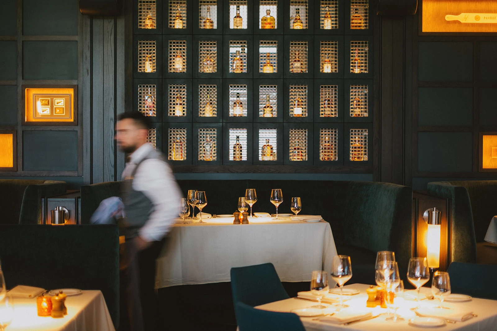 a man standing behind a table with glasses