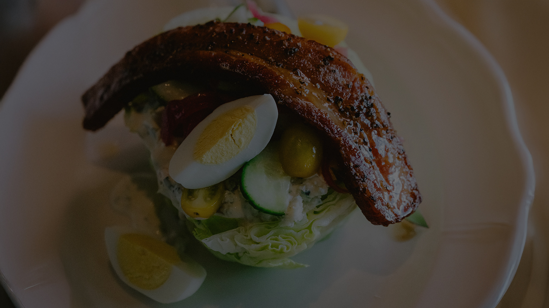 a bacon egg and lettuce salad on a plate