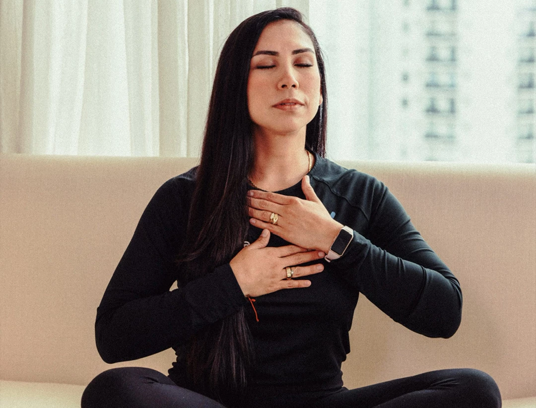 a woman sitting on a couch with her eyes closed