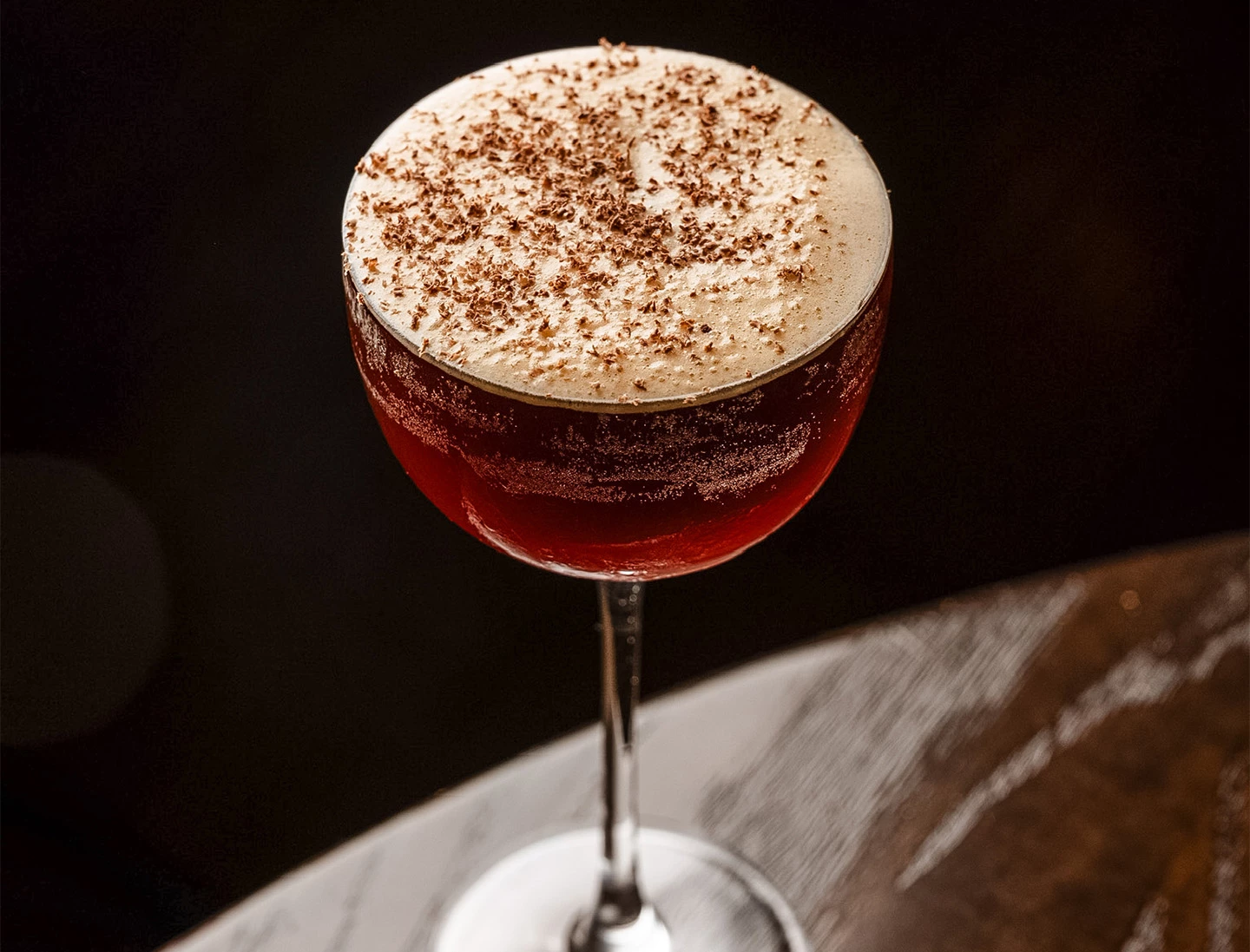 a glass of brown liquid with brown liquid and brown sprinkles