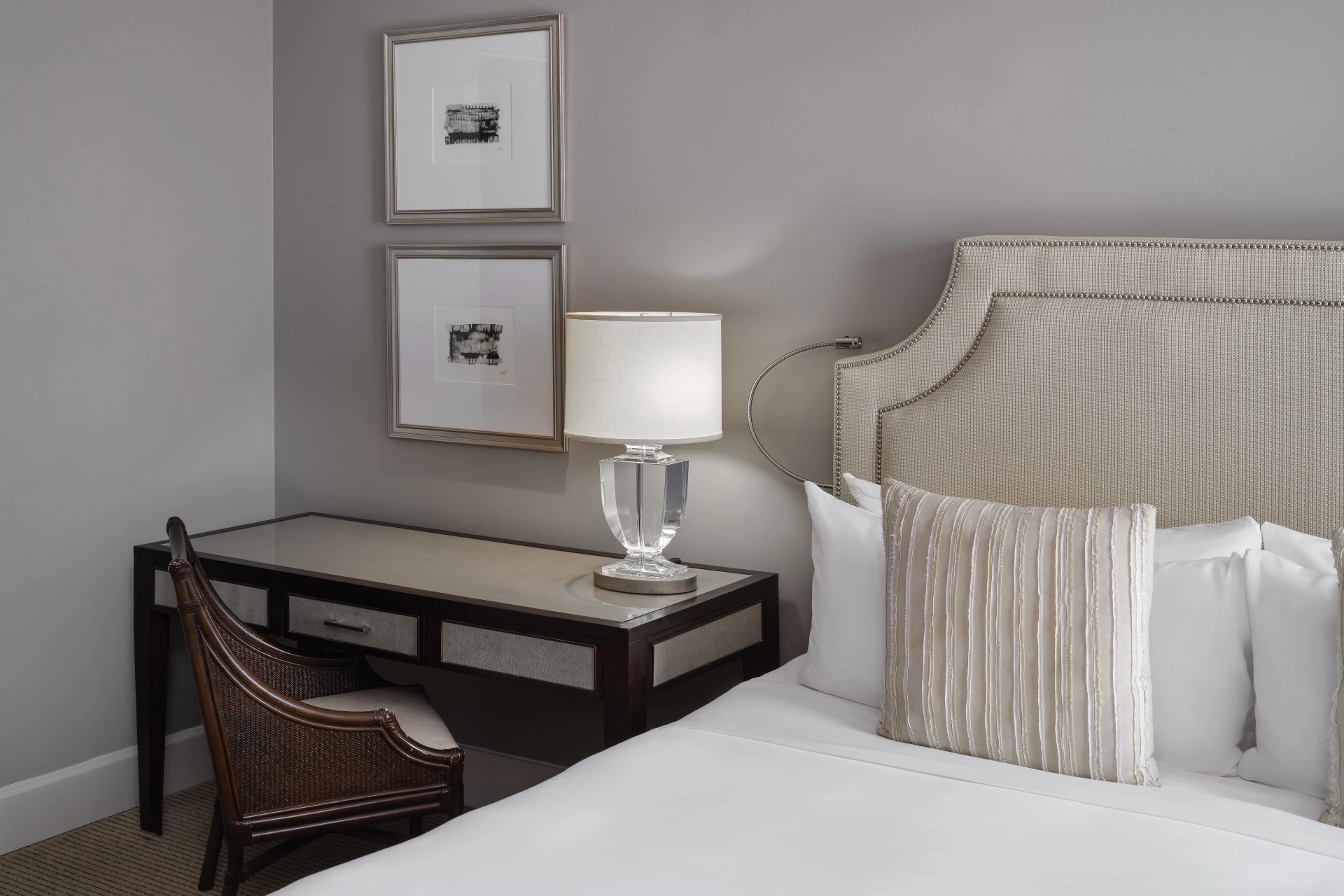 a bed with a lamp on a desk