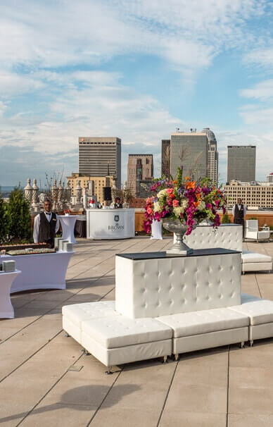 a group of white couches with flowers on top of each other
