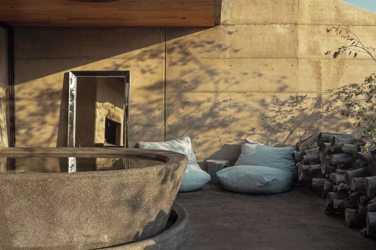 a stone fountain with pillows and a round stone bowl
