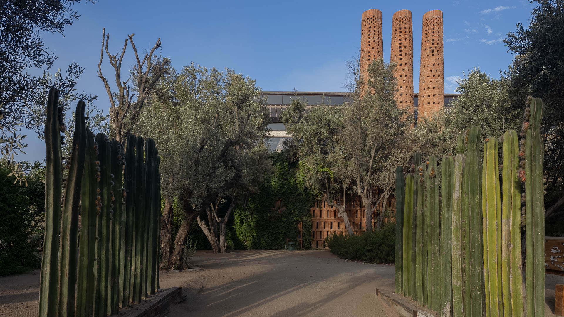 a path with a brick tower in the background