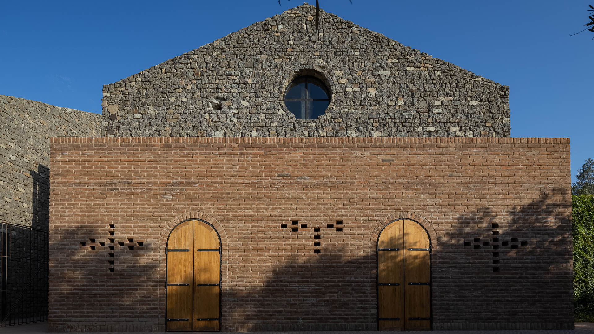 a brick building with a round window