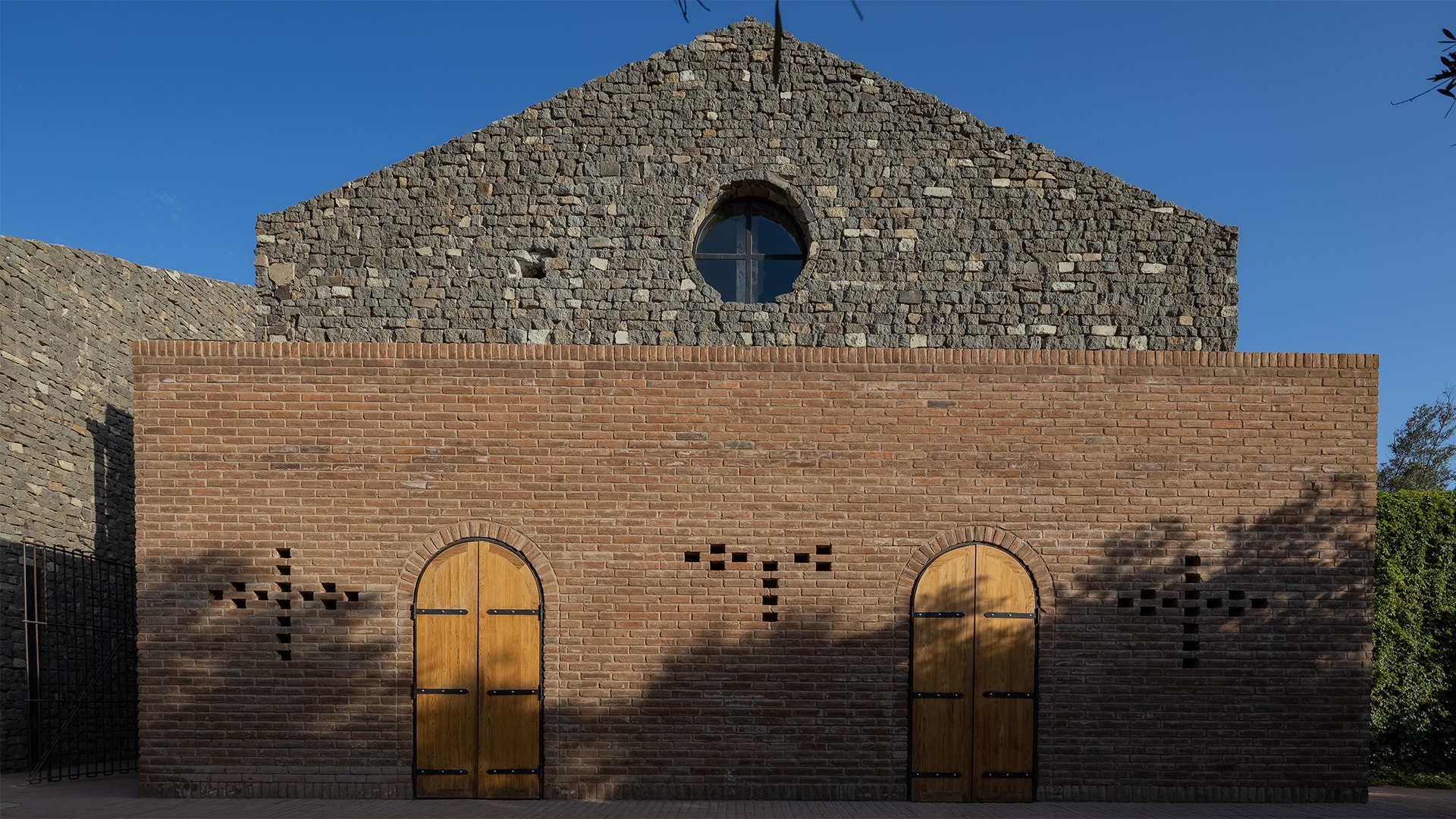 a brick building with a round window