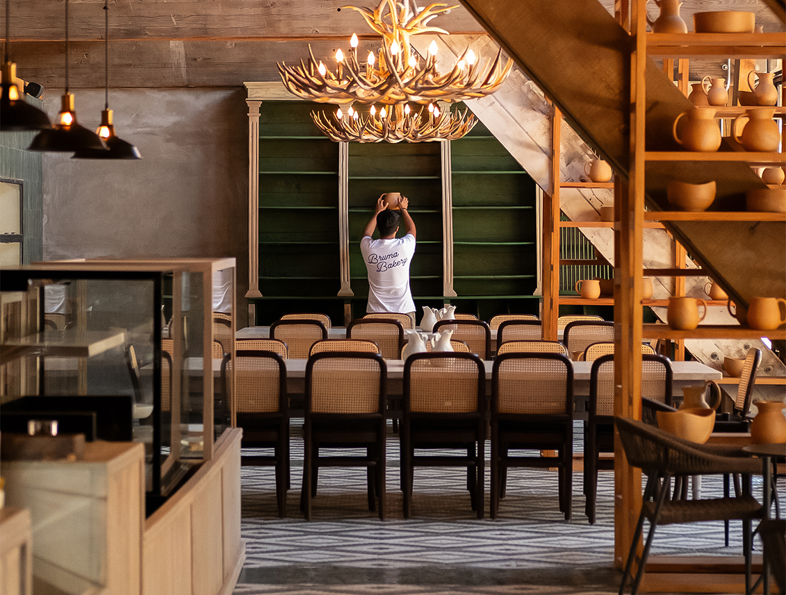 a person standing in a room with a chandelier