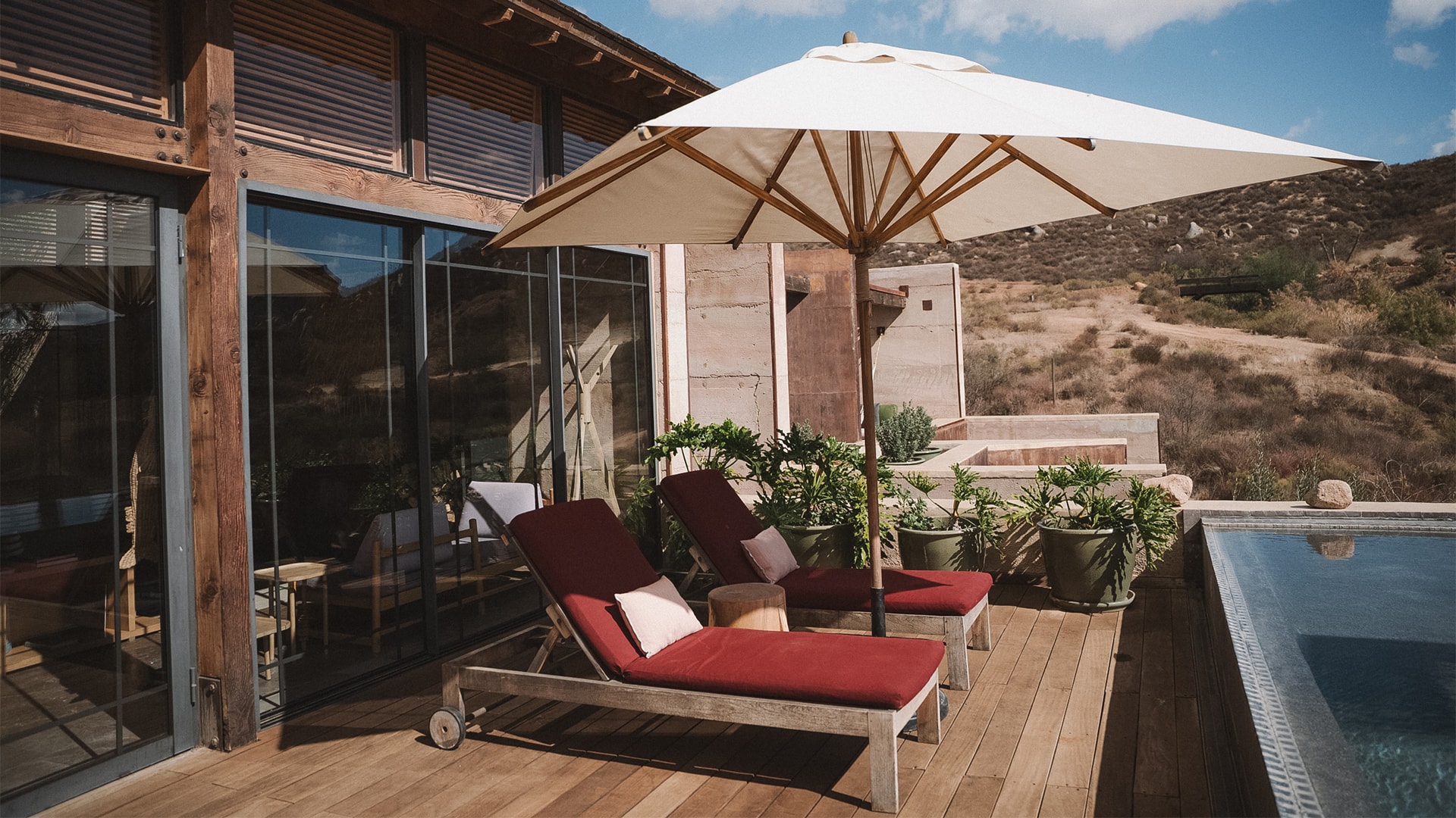 a deck with chairs and umbrella