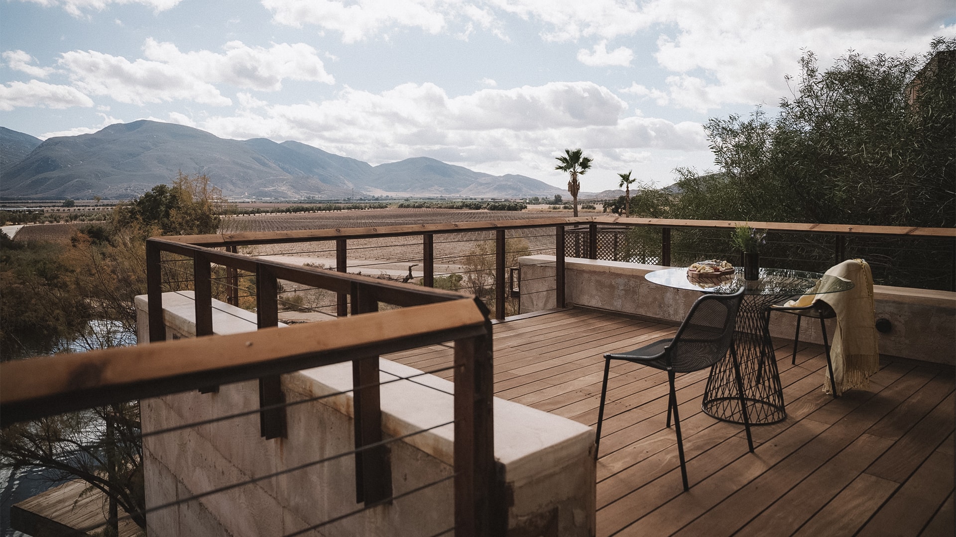 a deck with a table and chair