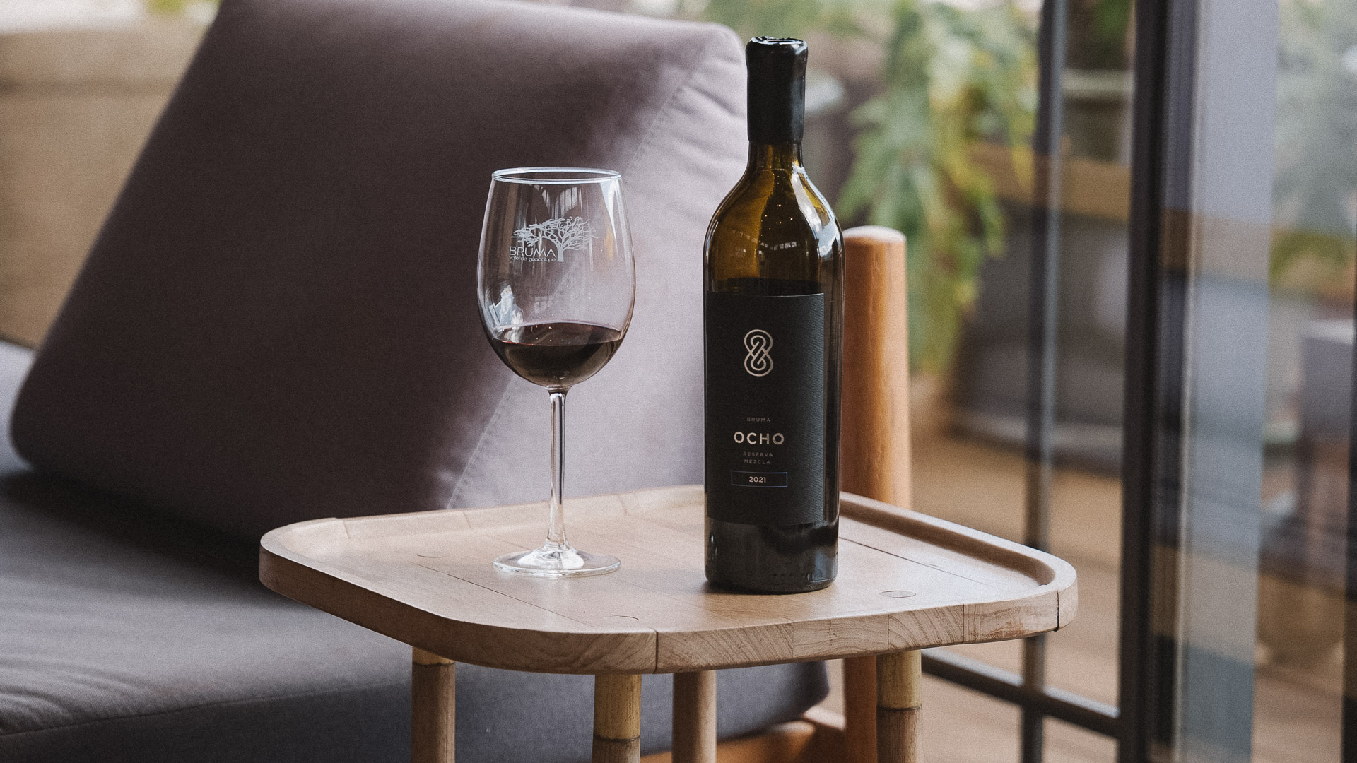 a bottle and glass of wine on a table