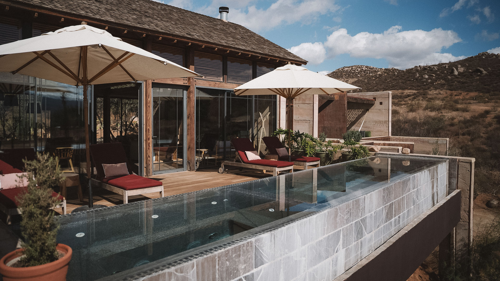 a patio with chairs and umbrellas