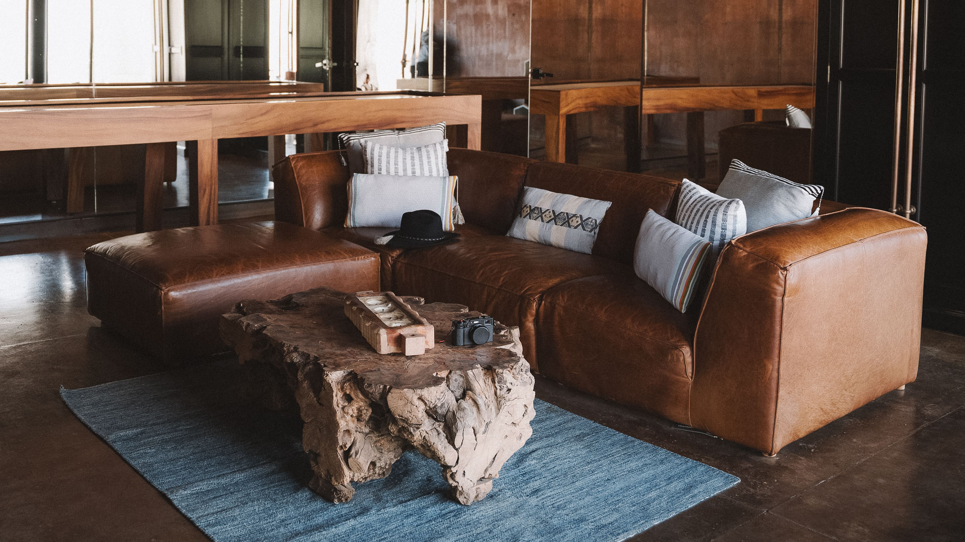 a couch with pillows and a table on the floor