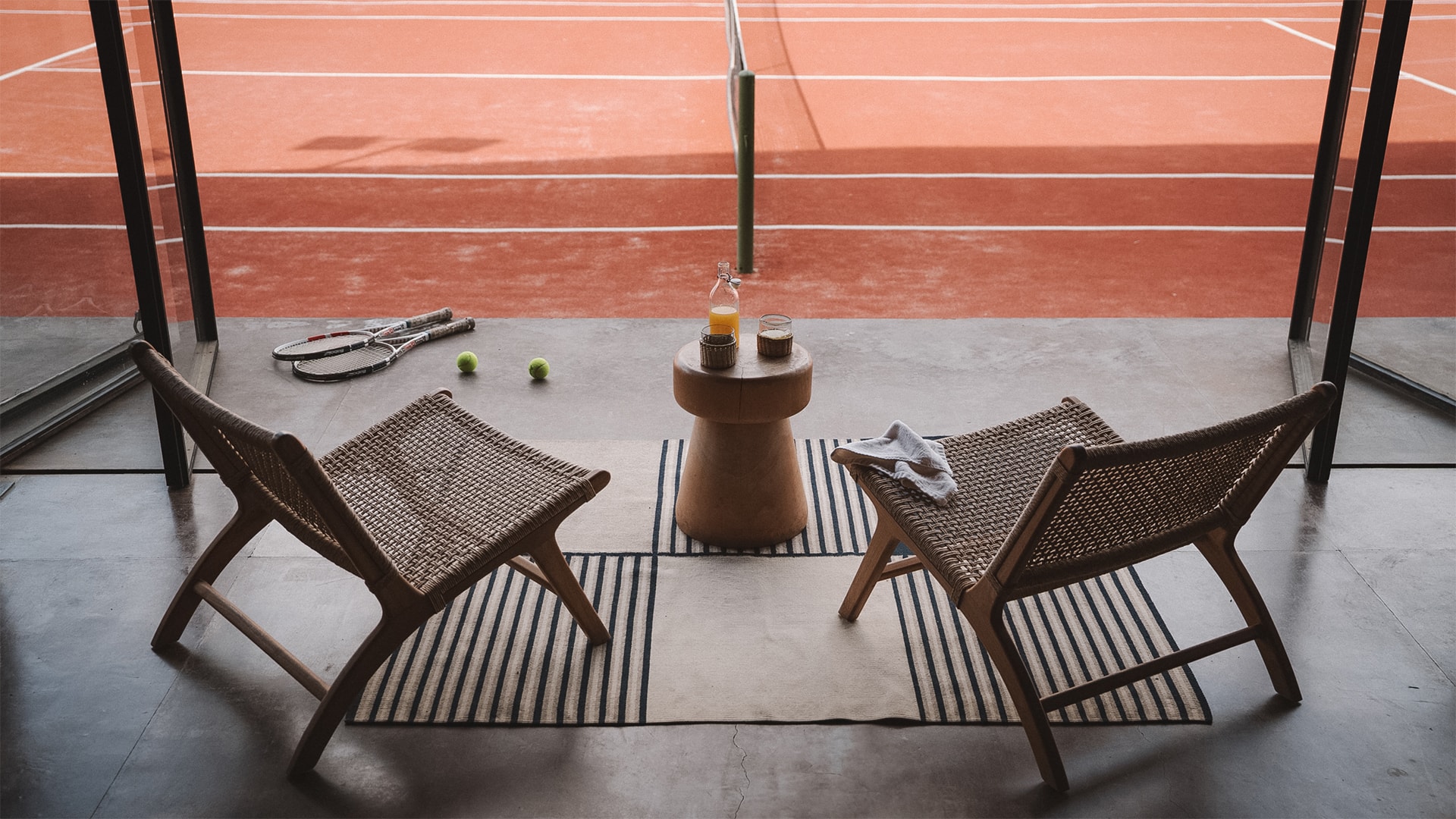 a tennis racket and chairs on a tennis court