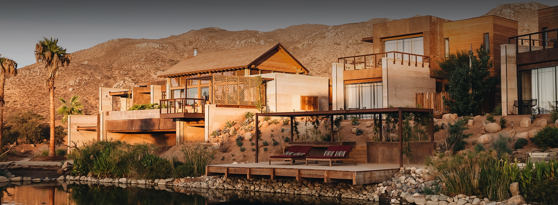 a house with a lake and a couch on a dock