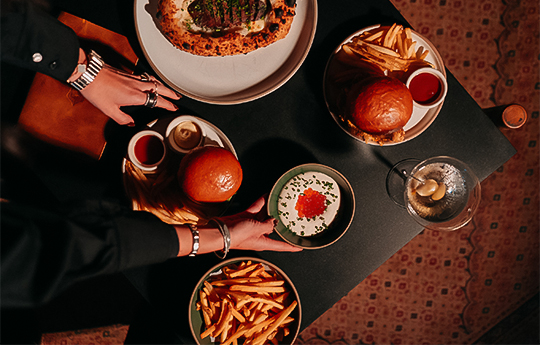 a person holding plates of food