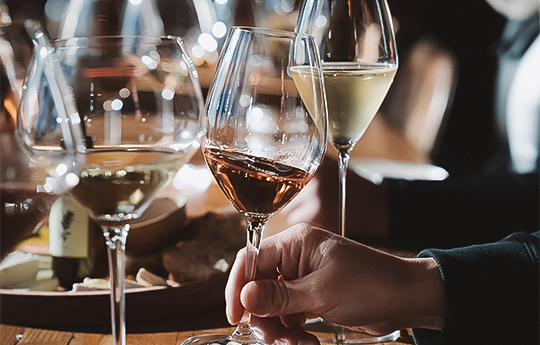 a hand holding a wine glass