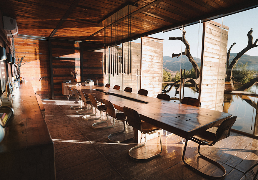 a room with a long table and chairs