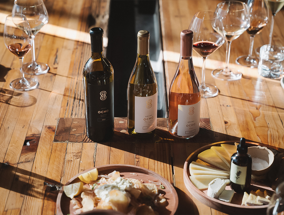 a table with wine bottles and food on it