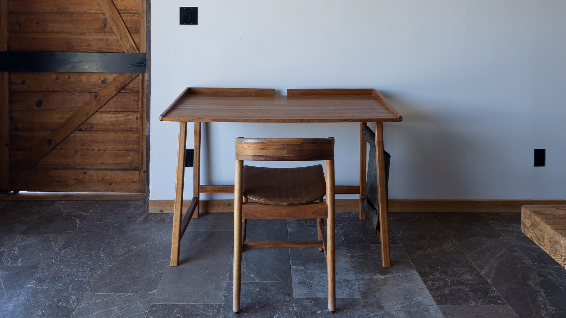 a wooden table and chair in a room