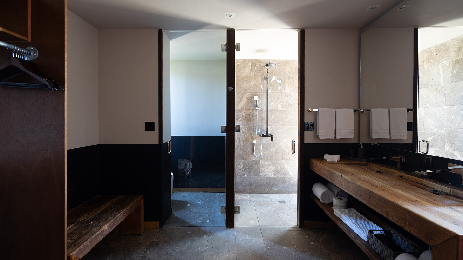 a bathroom with a shower and a bench