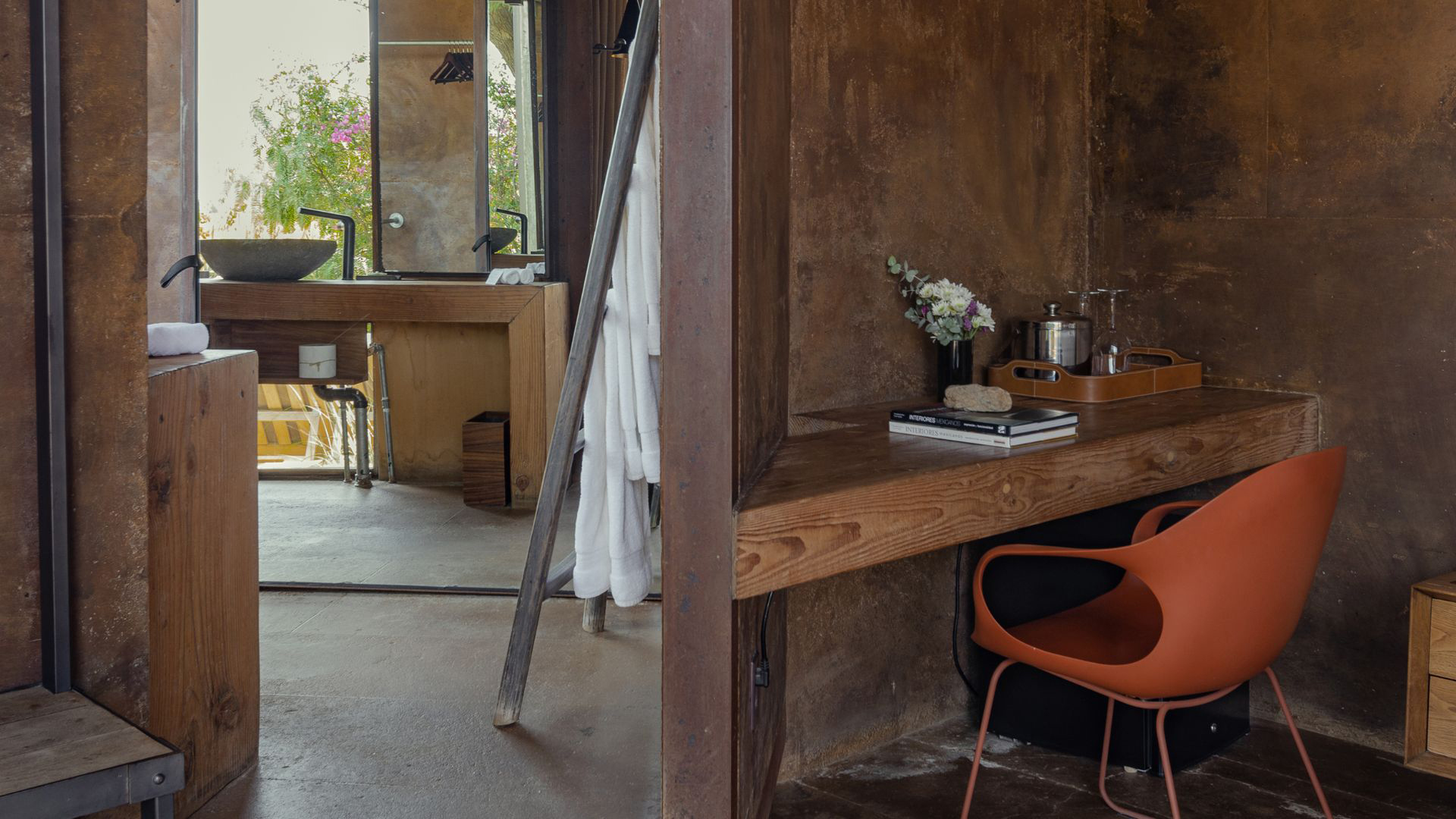 a bathroom with a mirror and a chair