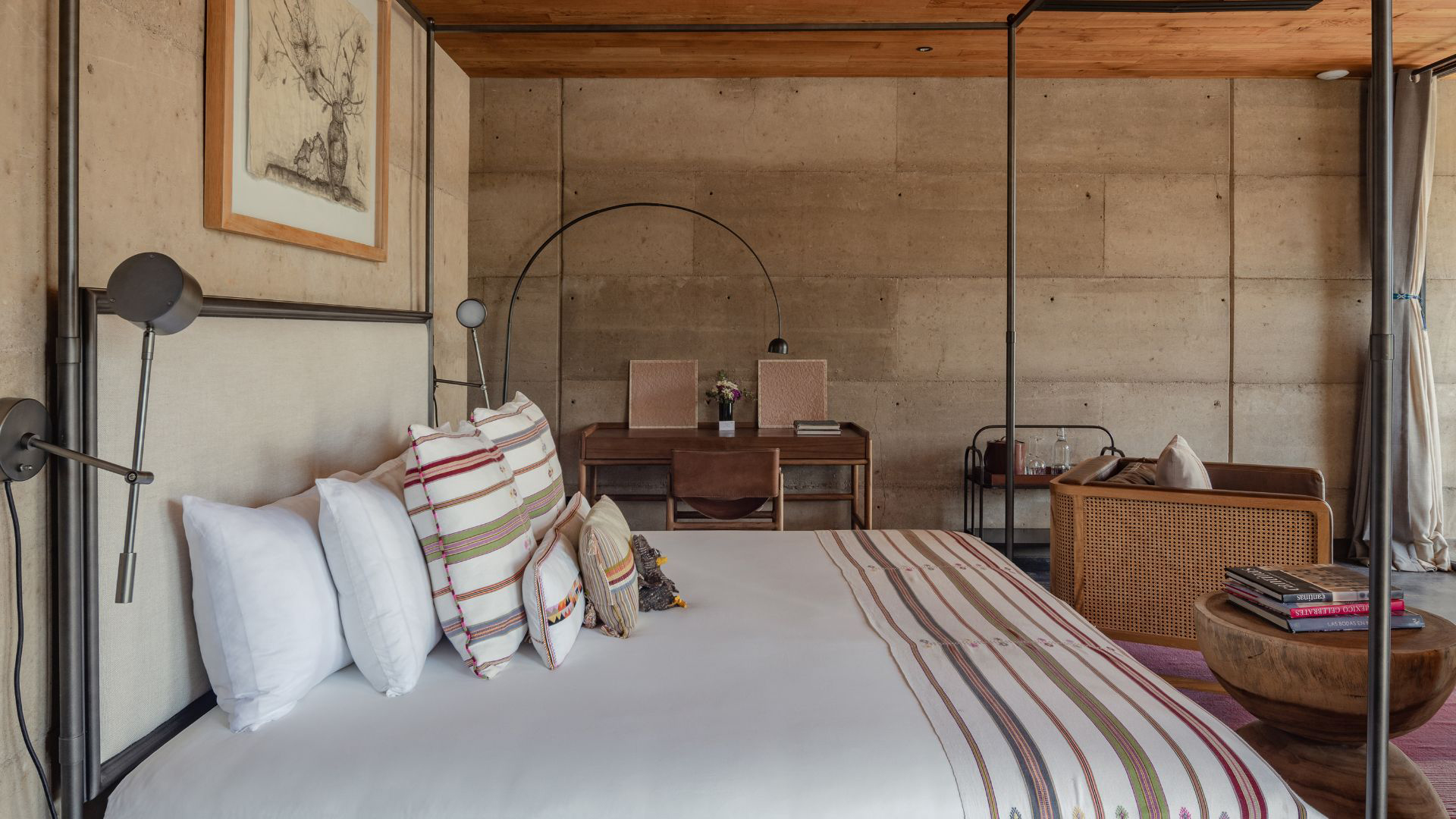 a bed with pillows and a table in a room