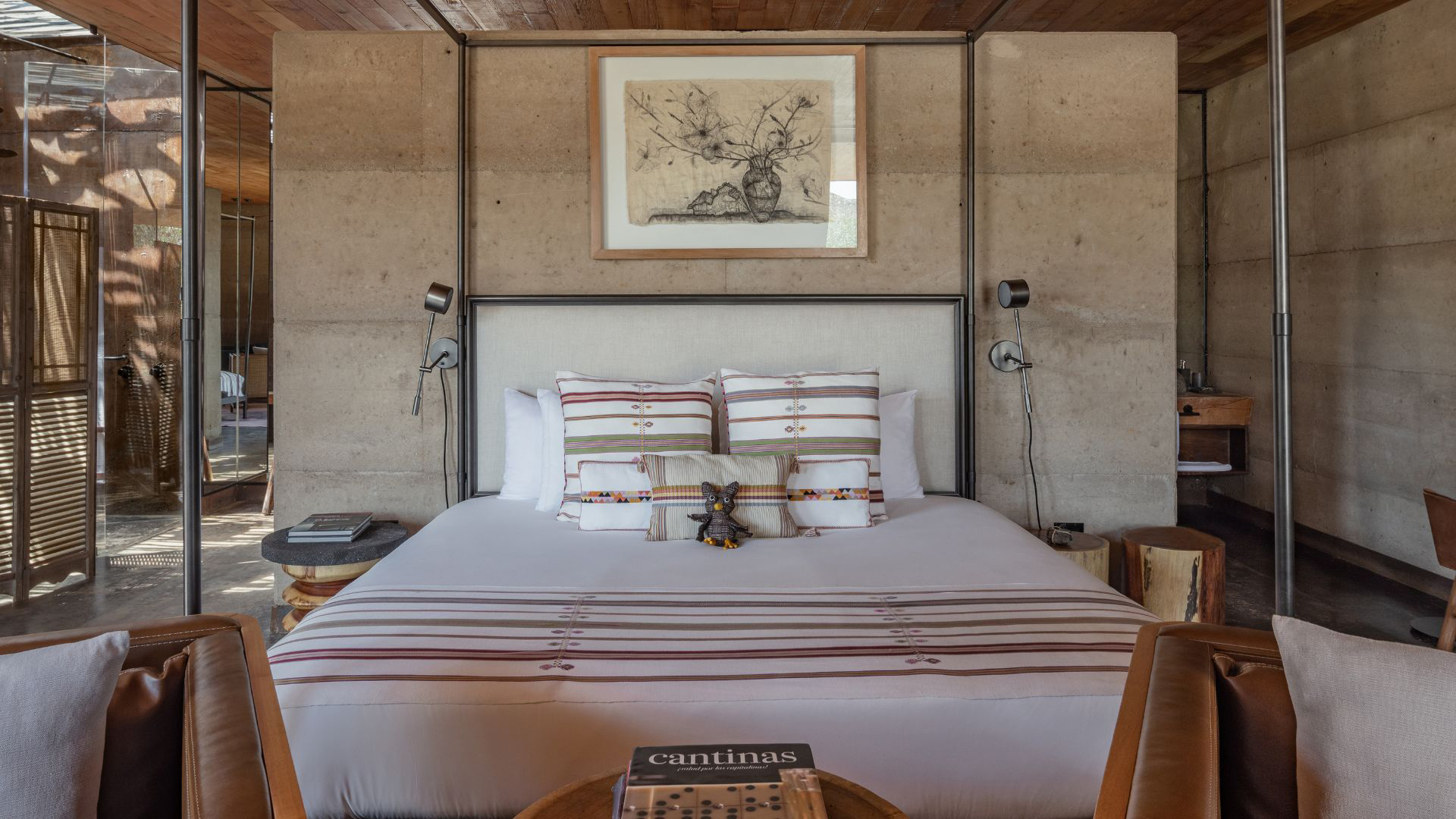 a bed with pillows and a picture on the wall