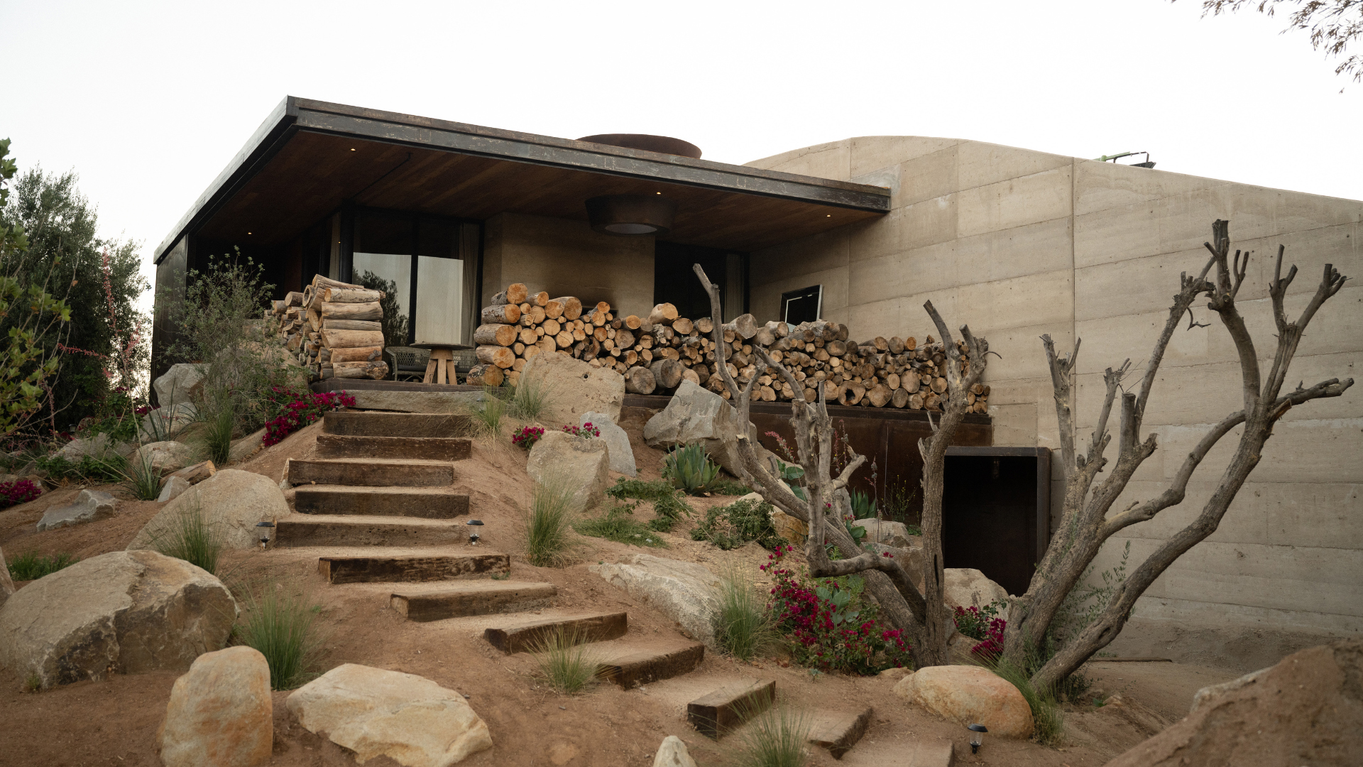 a house with a stack of wood