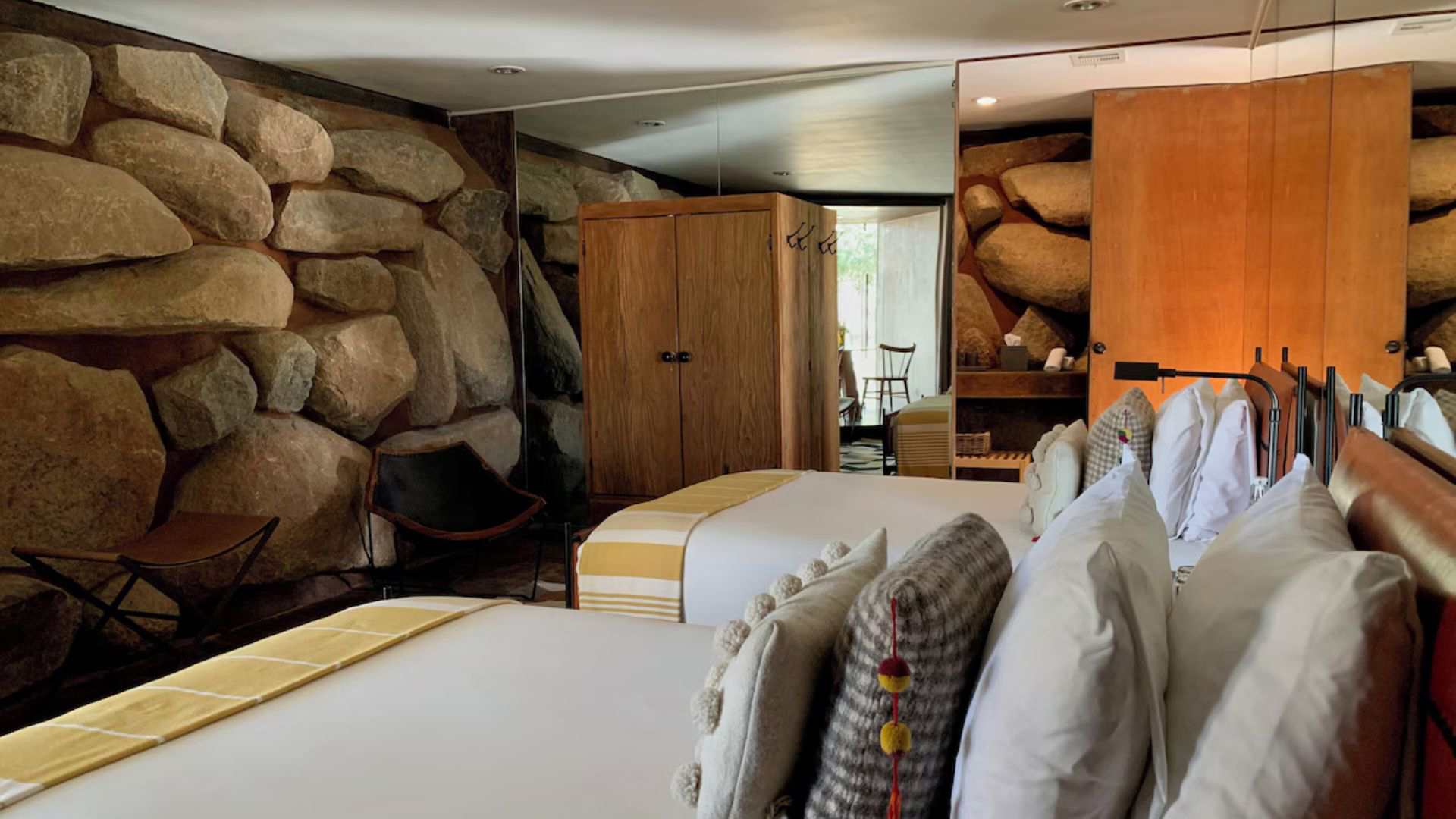 a room with two beds and a mirror